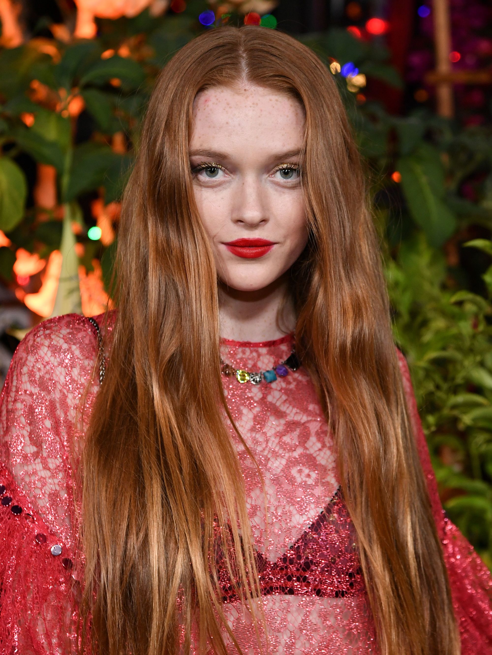 cute long hairstyles: close up shot of larsen thompson with long loose waves, wearing netted top and posing