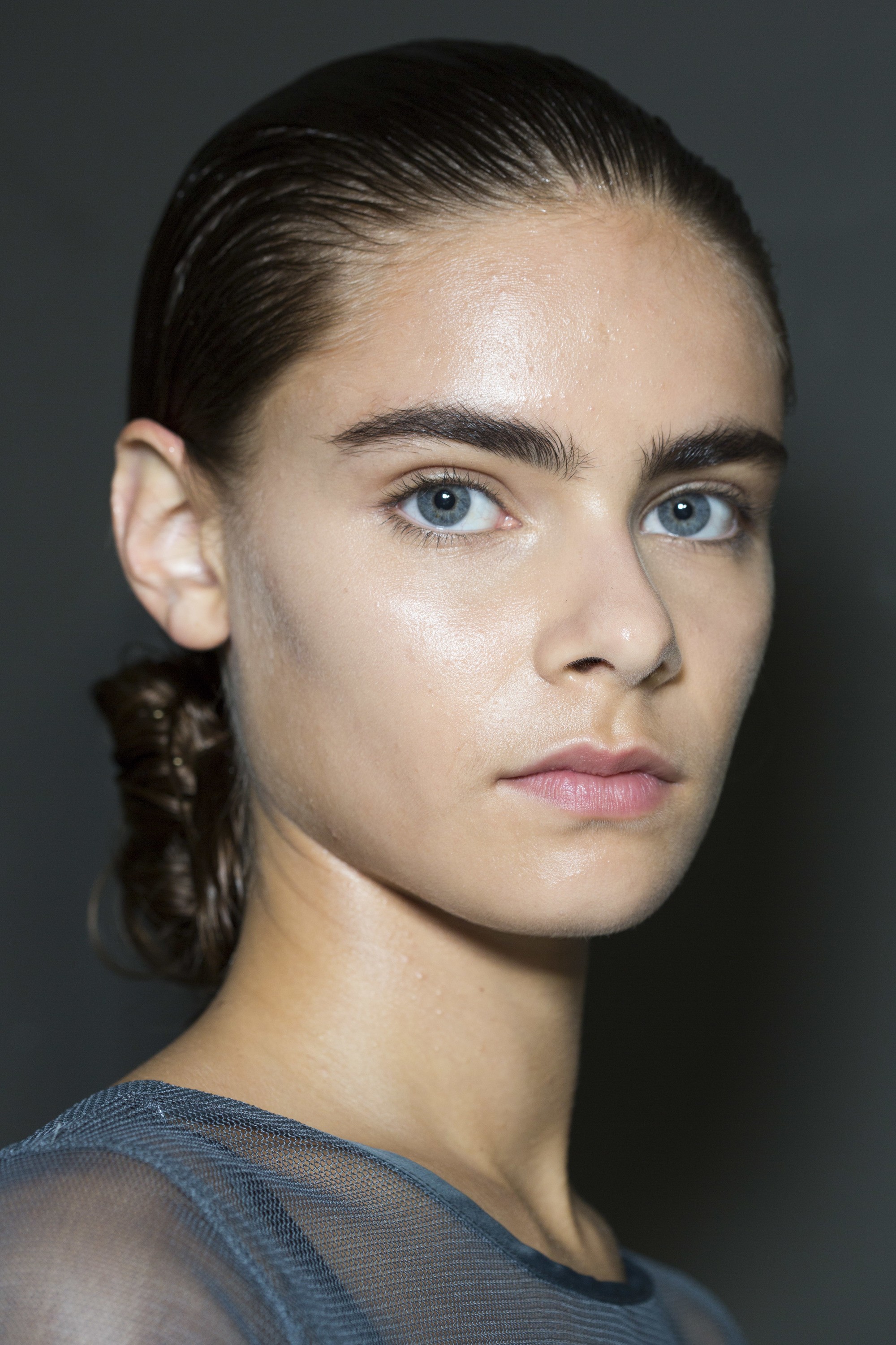 brunette model with a rectangle face with a low bun hairstyle