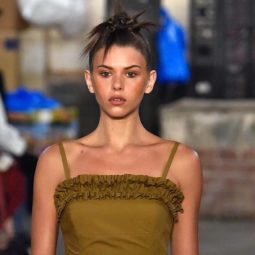 London Fashion Week SS19 brunette model at Molly Goddard with a '90s inspired knotted updo with loose spiky pieces around the face