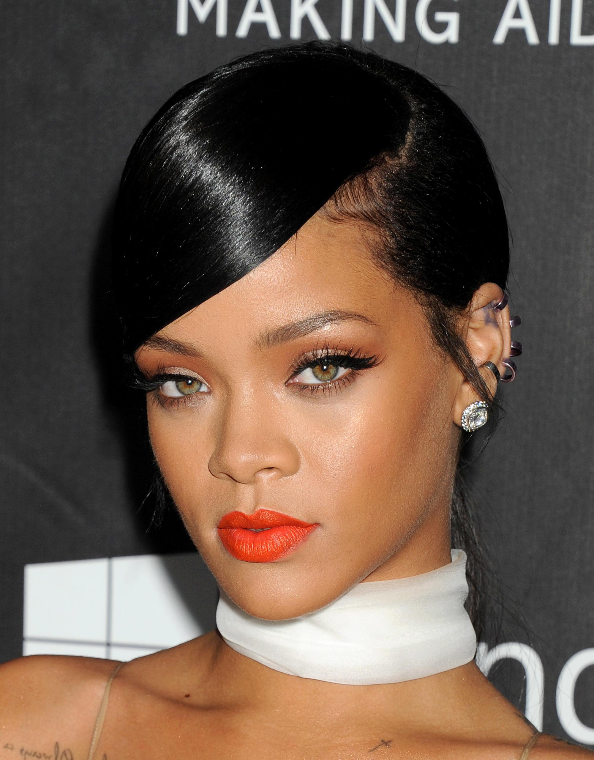 rihanna side parted updo with sweeping fringe on dark brown hair