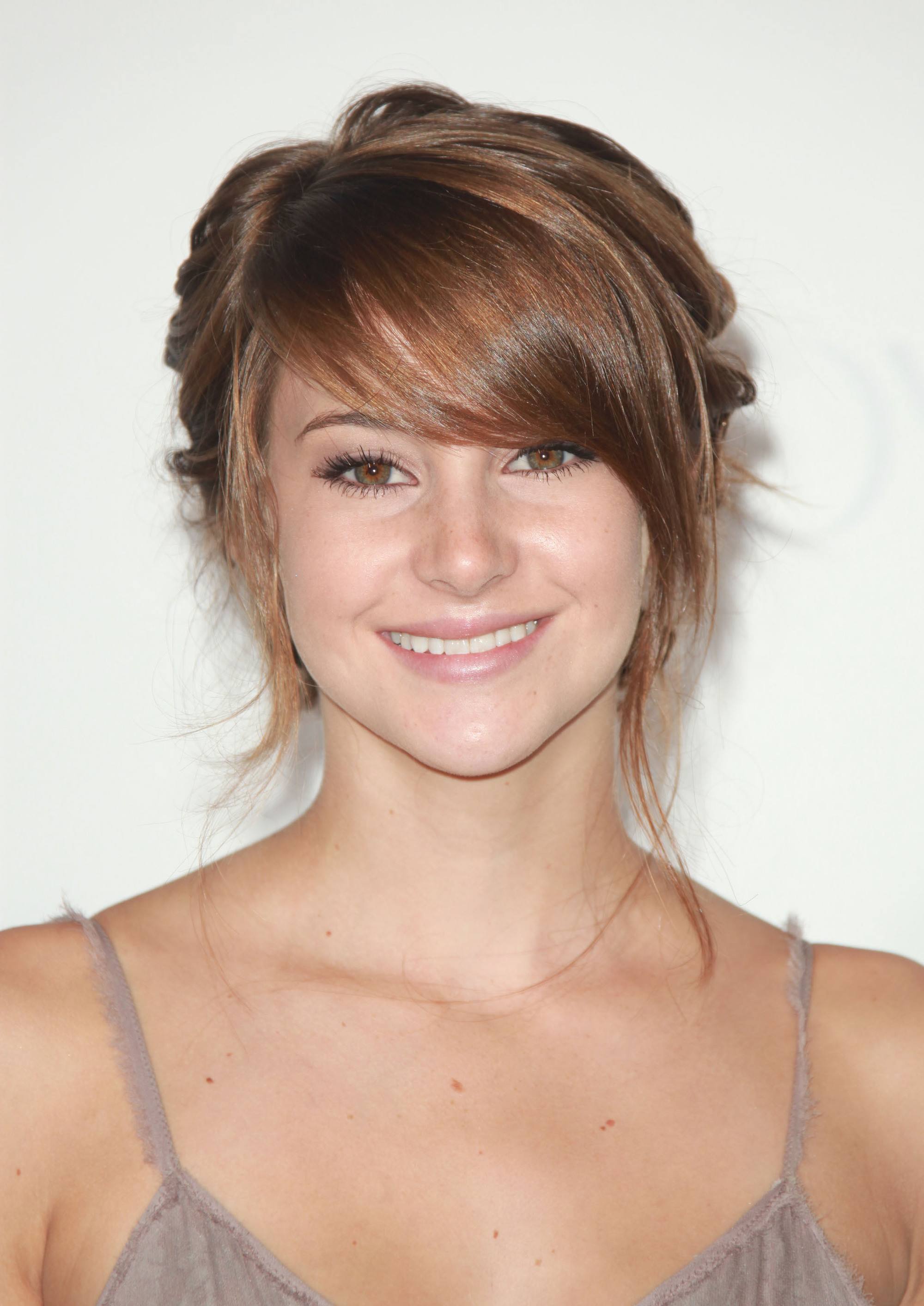actress shailene woodley with soft brunette swoop bangs in an updo