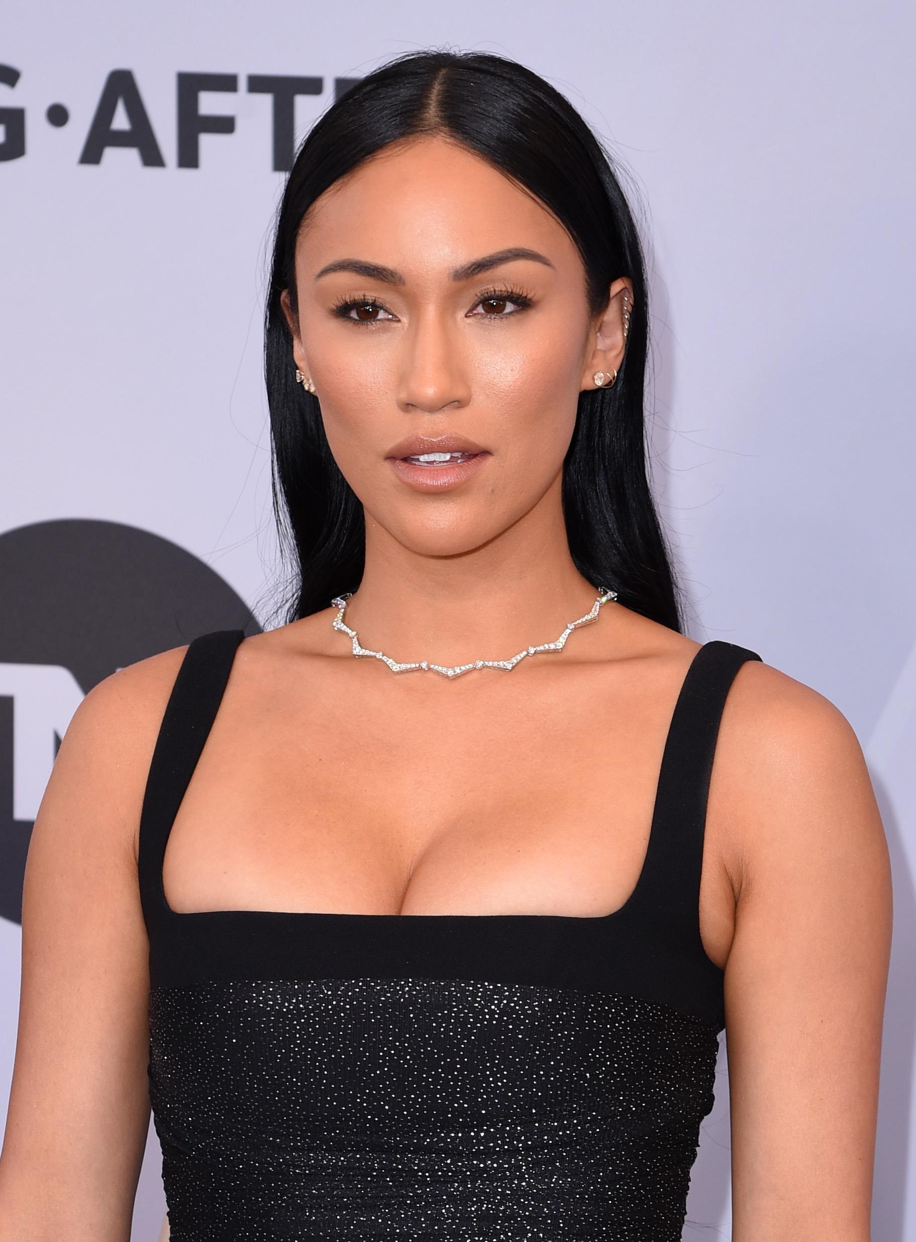 Celebrity Valentine's Day Hair: Close up shot of Stephanie Shepard with long, straight dark hair, wearing a black square cut dress on the red carpet