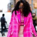 Black girl with curly hair walking outside fashion week show