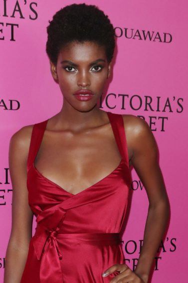 best deep conditioner for 4c hair: close up shot of amilna estevao with short afro hairstyle, backstage at Victoria's secret fashion show