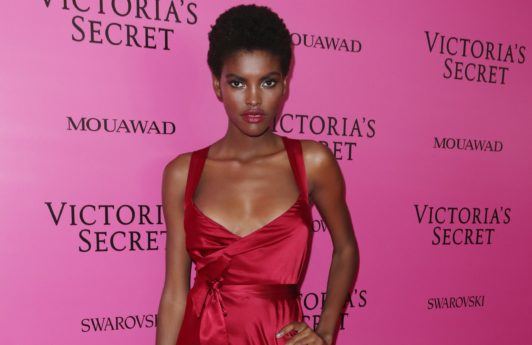 best deep conditioner for 4c hair: close up shot of amilna estevao with short afro hairstyle, backstage at Victoria's secret fashion show