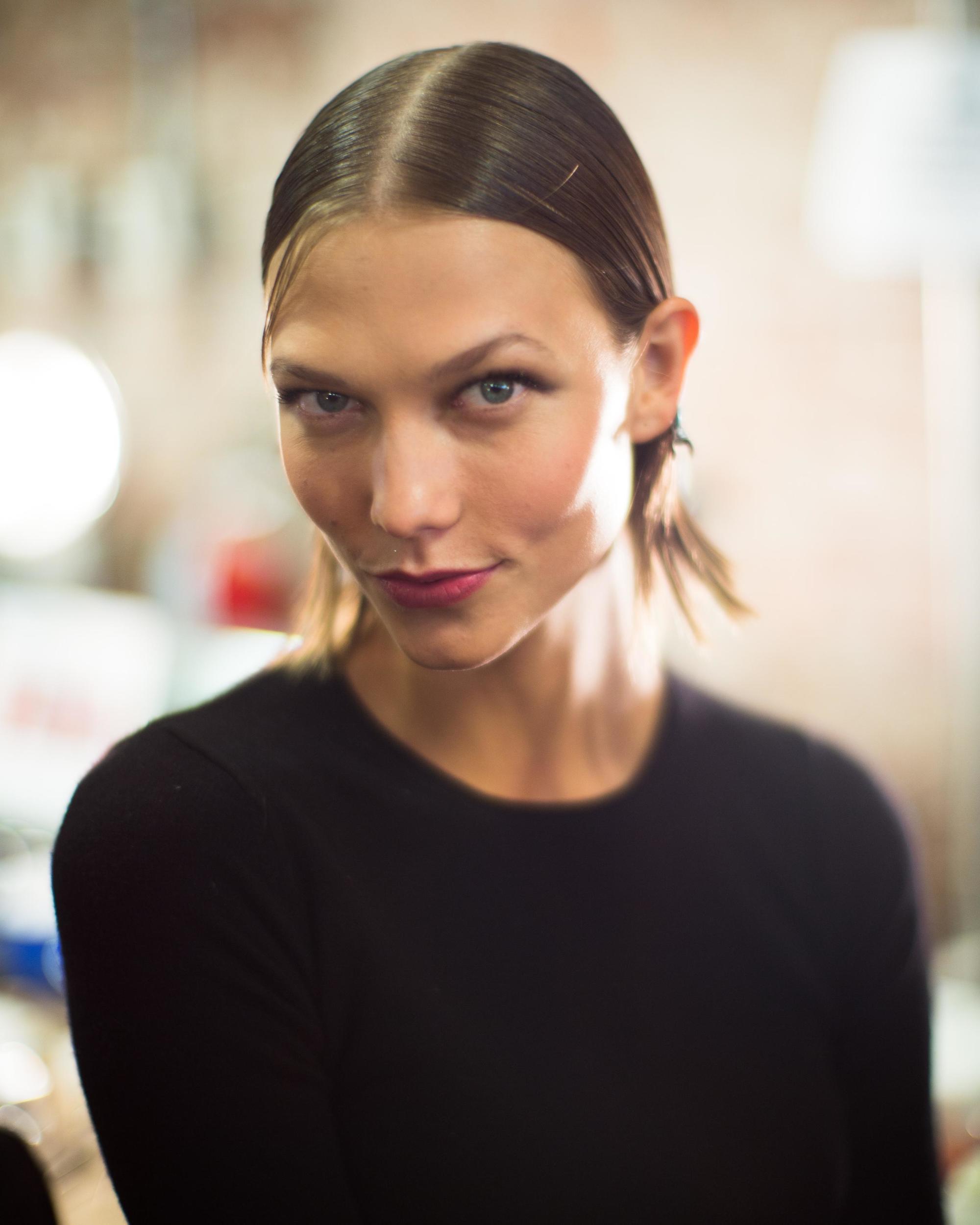 karlie kloss backstage at jason wu spring 2014 runway show with blonde bob hair in middle parting wet look style