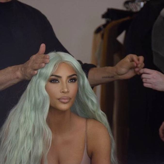 Green hair: Kim Kardashian West with long light pastel mint green wavy hair getting her hair done.