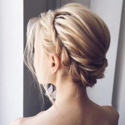 woman with light blonde hair in a prom updo with a rope braid headband detail