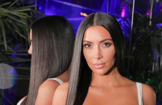 shampoo for straight hair: close up shot of kim kardashian west with the long straight hair, wearing sports bra and dress at the balmain and beats by dre event