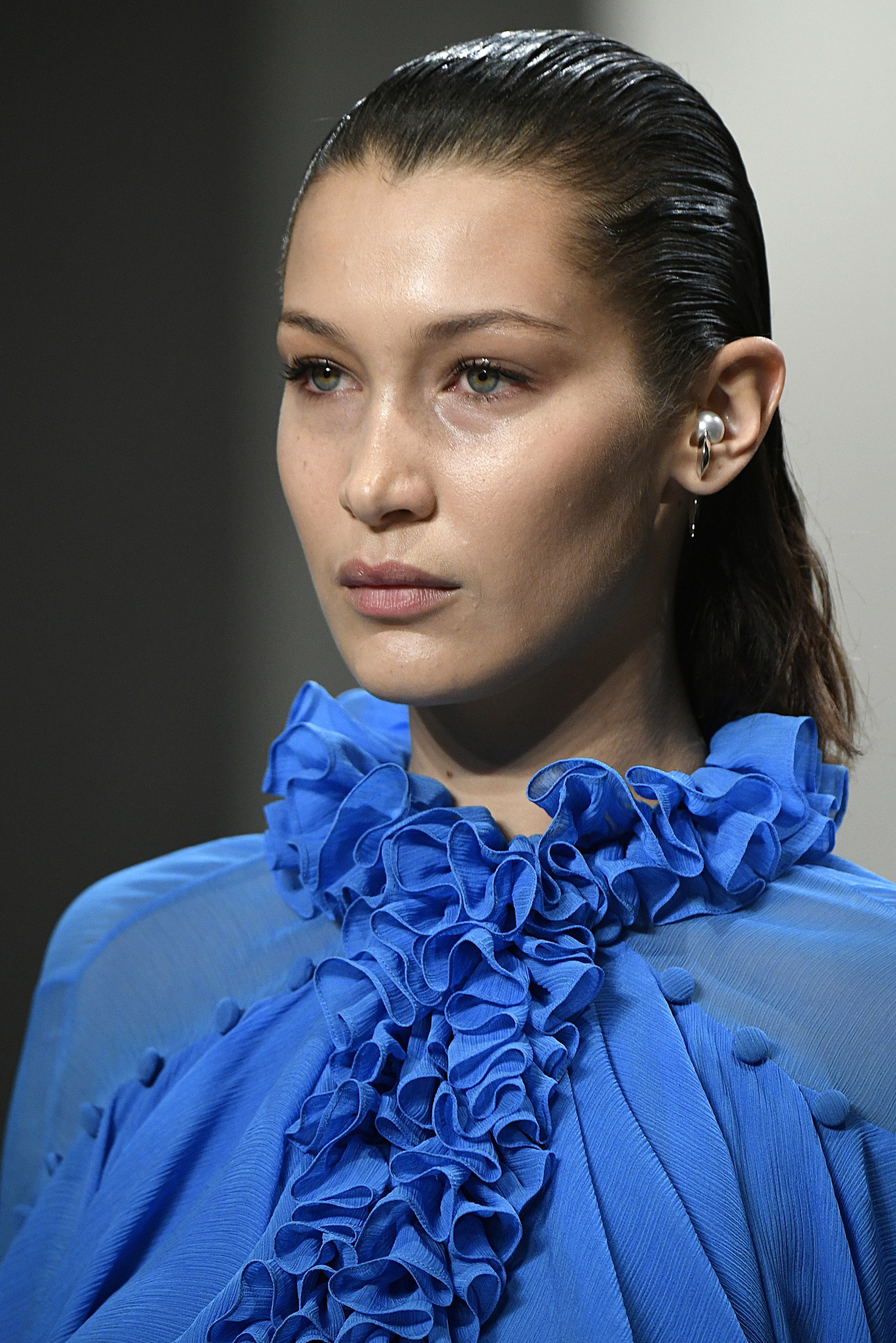 bella hadid dark brown wet look smoothed back hair on runway
