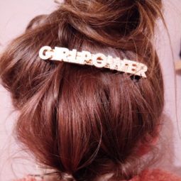 leona messy high bun on brown hair with statement hair slide wearing pink teddy coat