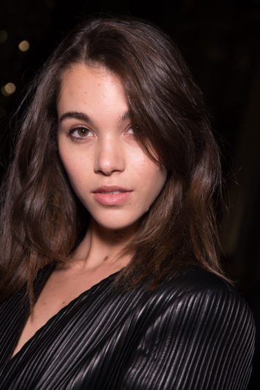 Hair thickening spray: close up beauty shot of a brunette model backstage at the balmain aw18 show with voluminous hair