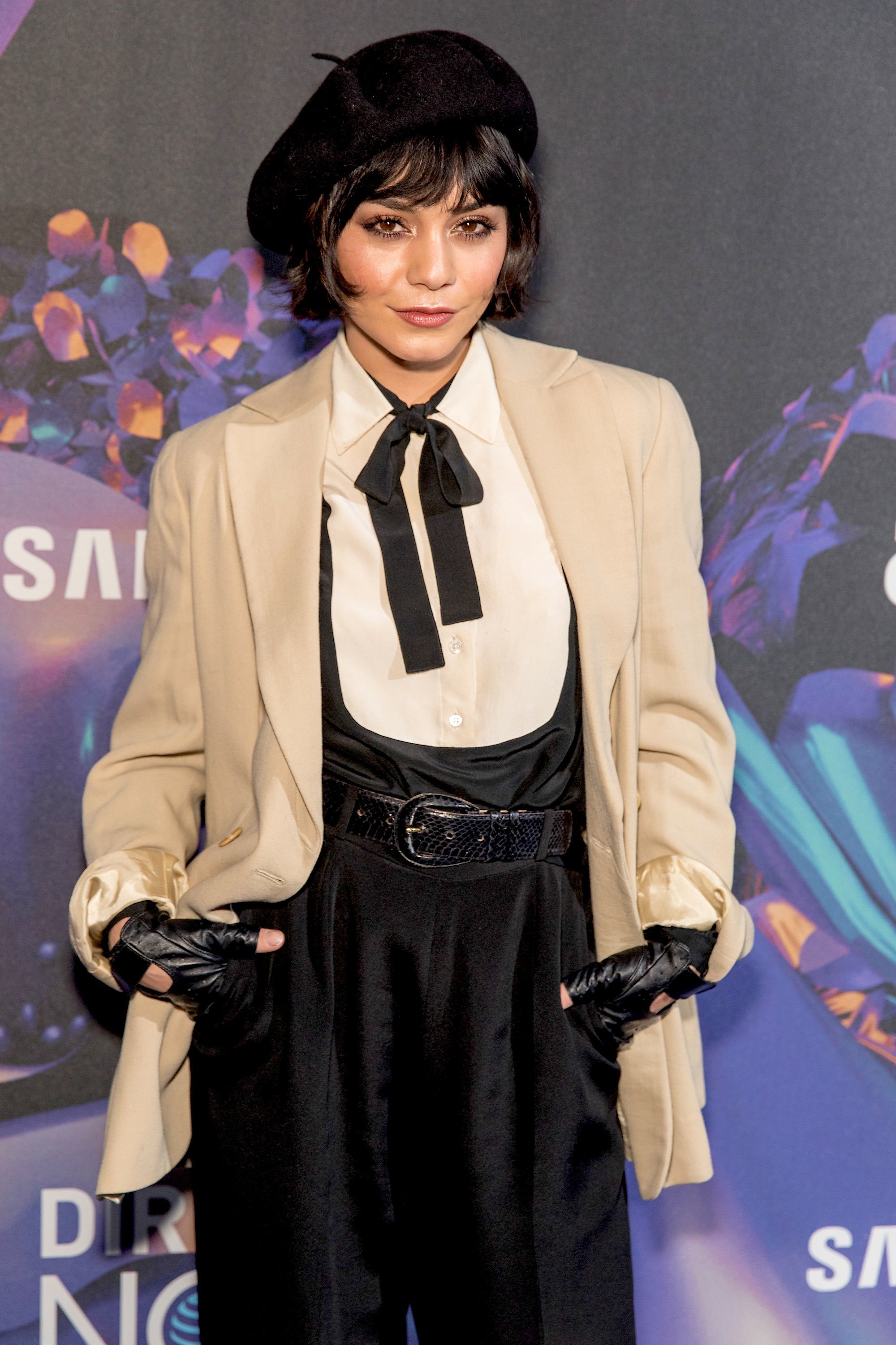 vanessa hudgens with dark brown bob and bangs chanel haircut with black beret and suit
