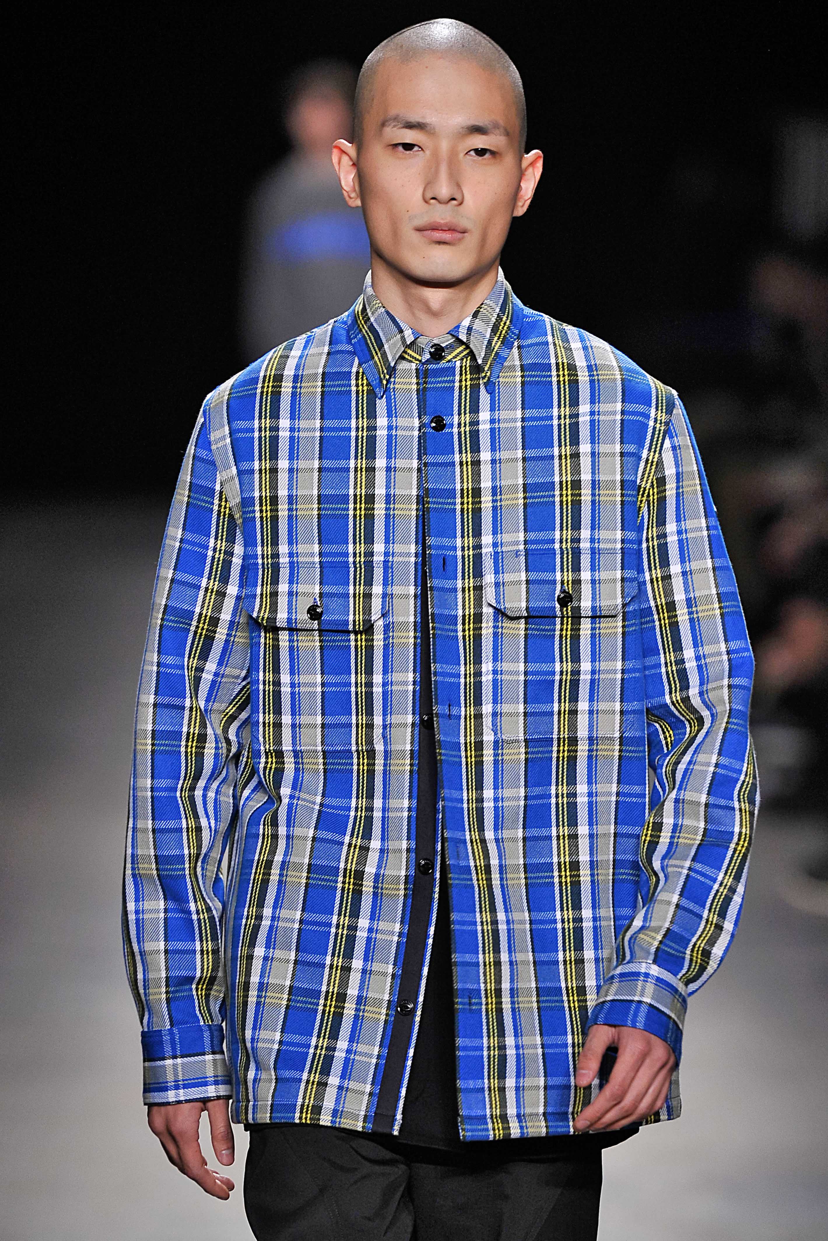 Asian man with shaved head on runway