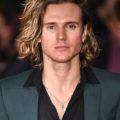 mcfly's dougie poynter on the red carpet with blonde medium length hair swept over to one side