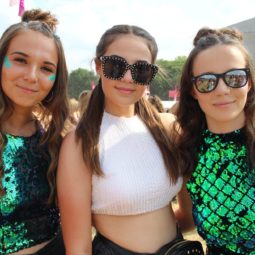 Festival hair must-haves: Three girls at Lovebox 2018 with brown hair styled in half-up, half-down braided bun s wearing green sequin dresses