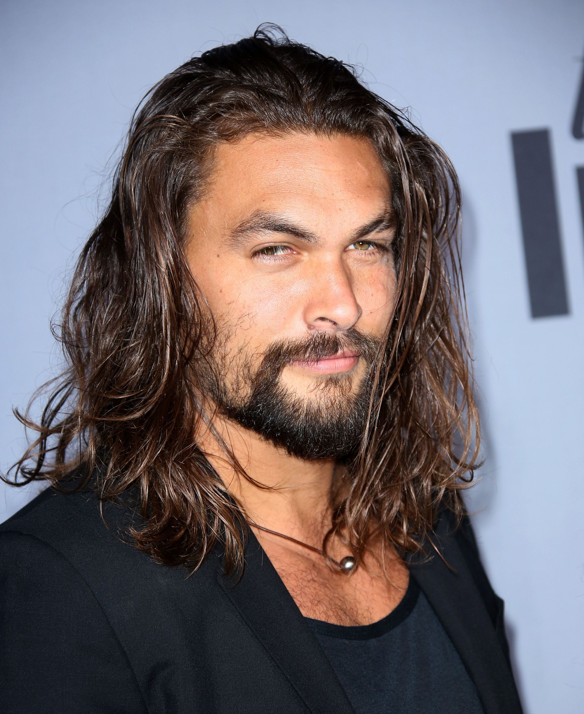 game of thrones actor jason momoa with long wild dark hair and heavy facial hair
