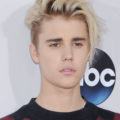 justin bieber with platinum blonde short hair with swooping face-framing layers