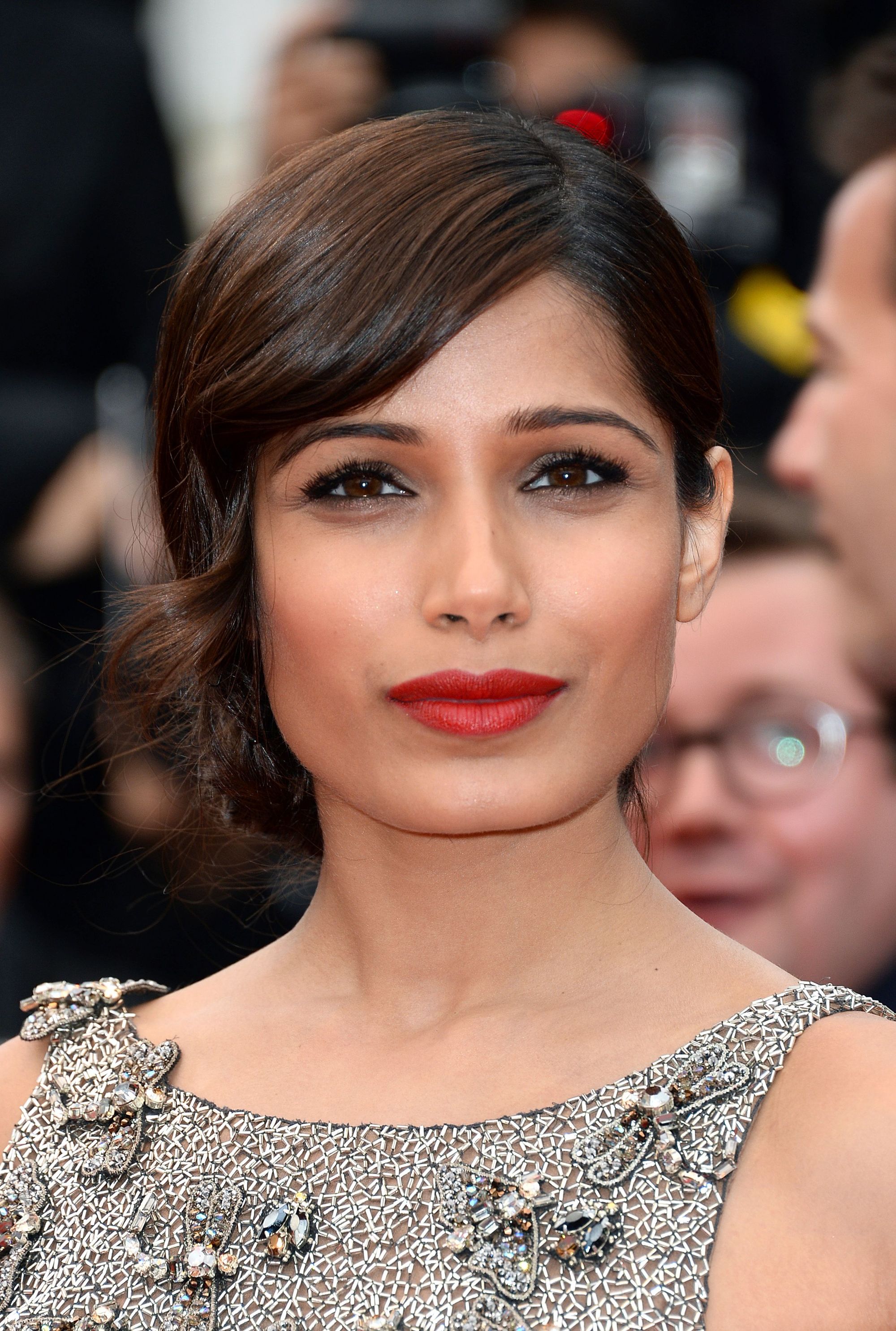 Freida Pinto on the red carpet with short brown hair in side parting wavy 1920s stye