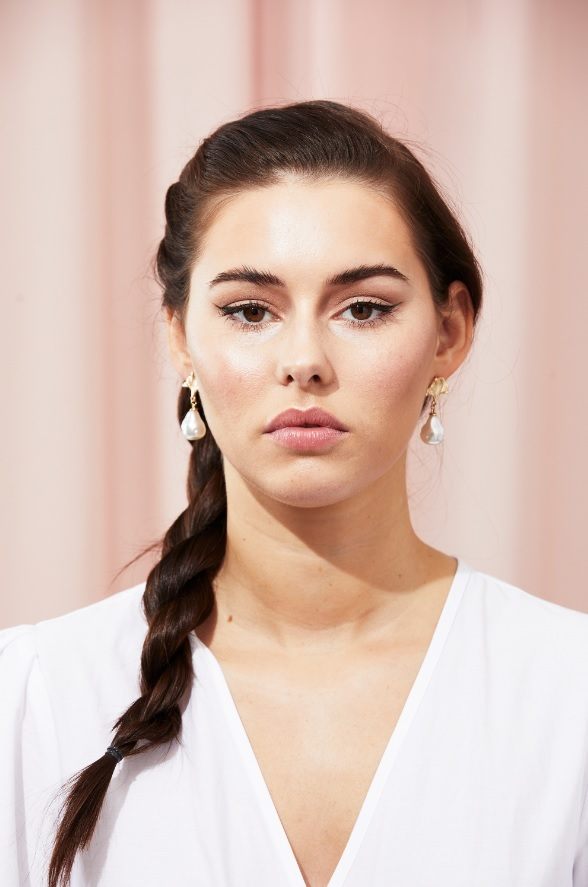 Brunette with a side low twisted ponytail