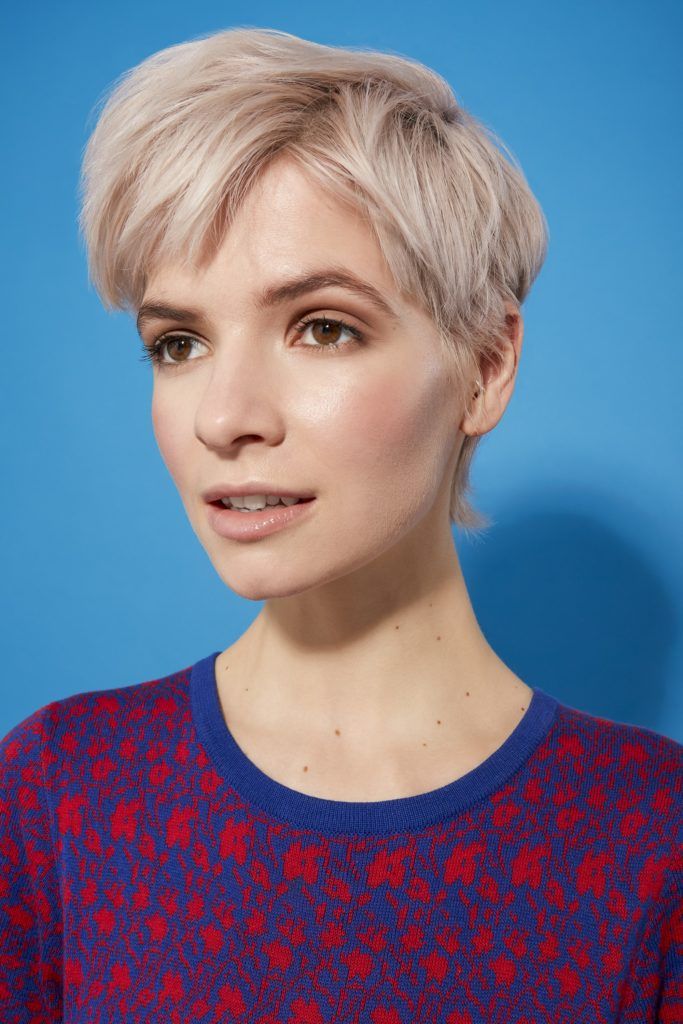 woman with platinum blonde hair in a pixie cut style