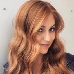 Summer hair colours: Woman with long light copper wavy hair