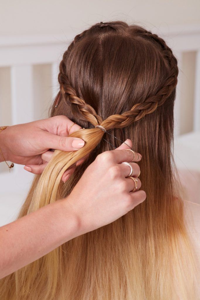 heart braid tutorial: close up shot of model with a heart braided hairstyle, which is being secured by an elastic band