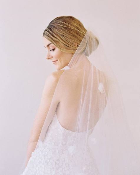 Wedding updos: Blonde bride with a low chignon and a veil
