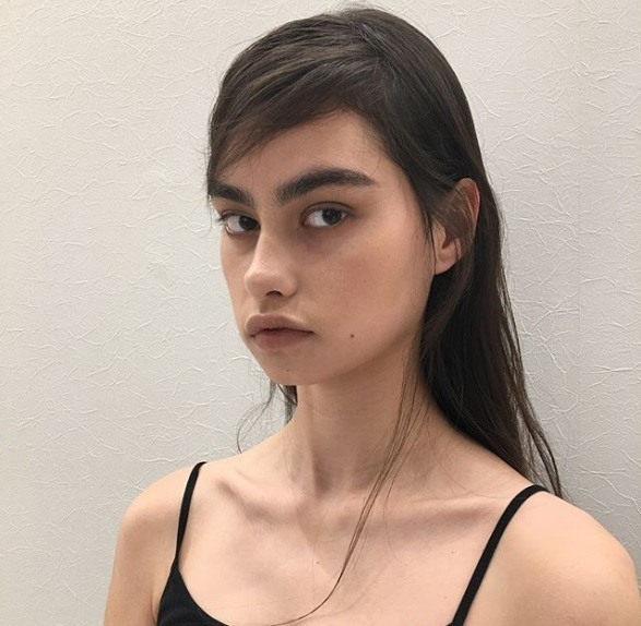 brunette haired model with a side parted wispy combover
