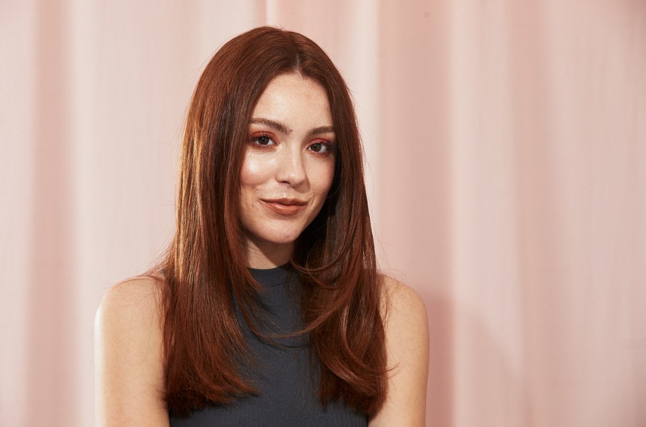 Brunette with medium length thick hair with face-framing layers
