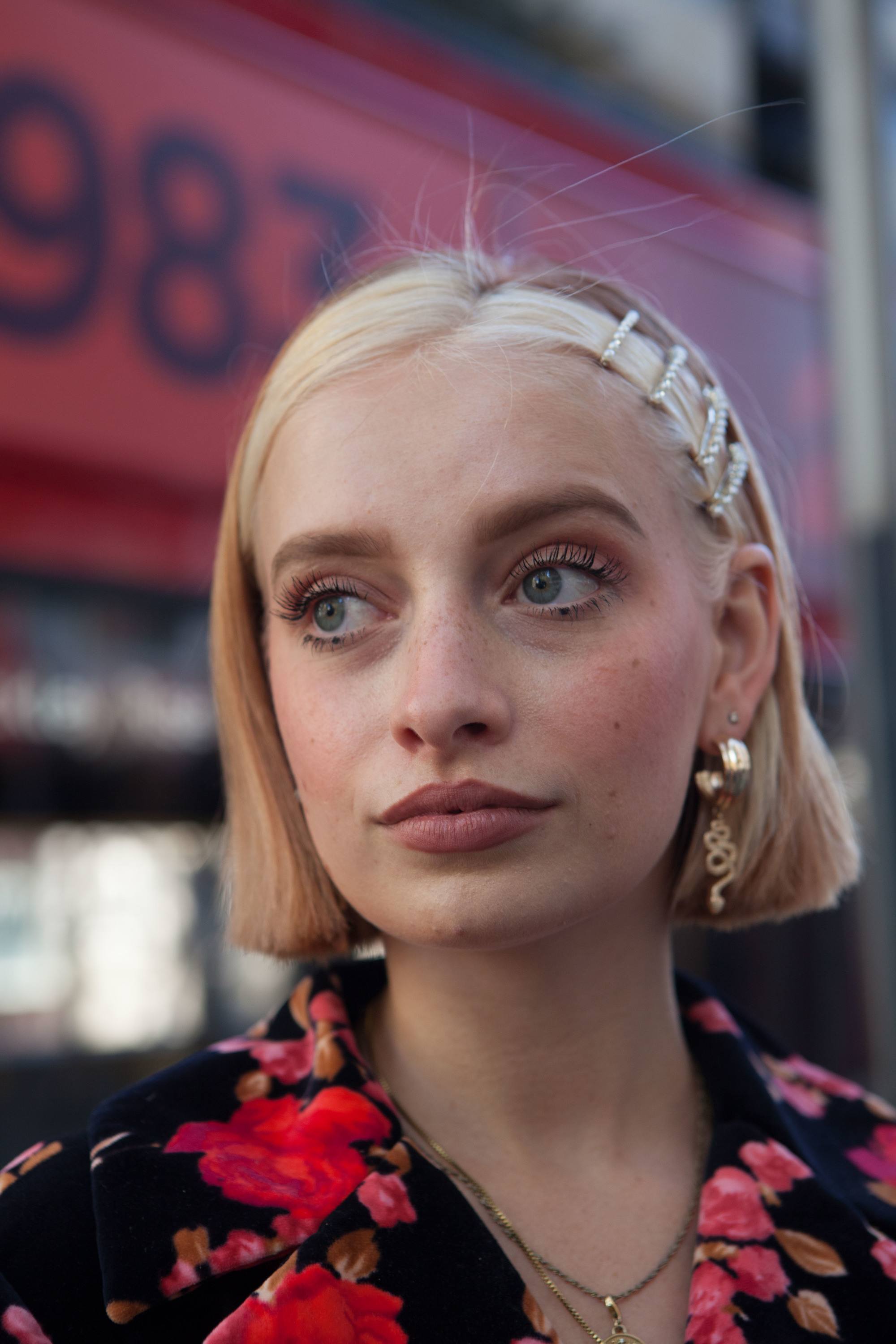 Woman with a short blonde blunt bob with hair slides