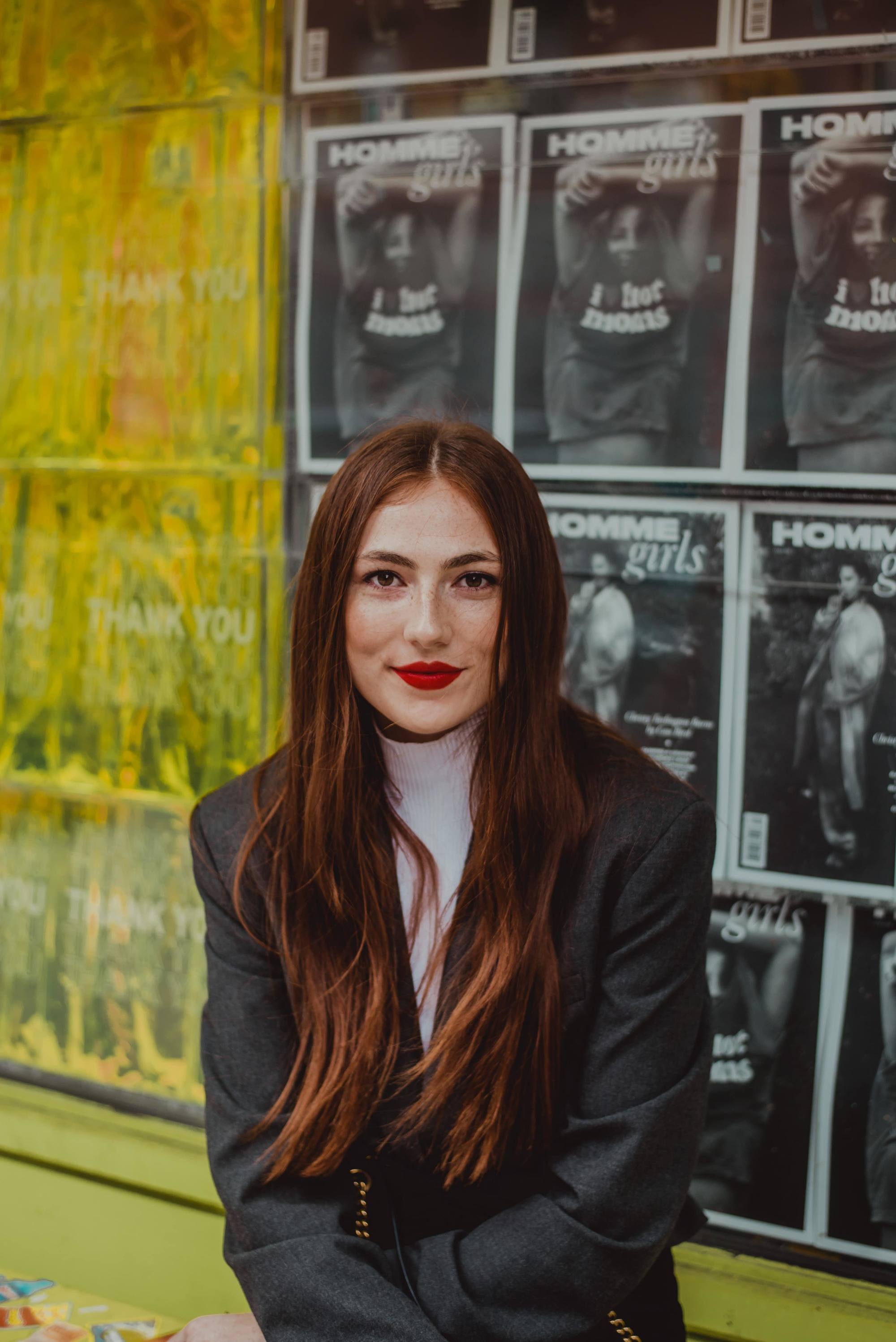 Woman with reddish brown long thick hair with long layers