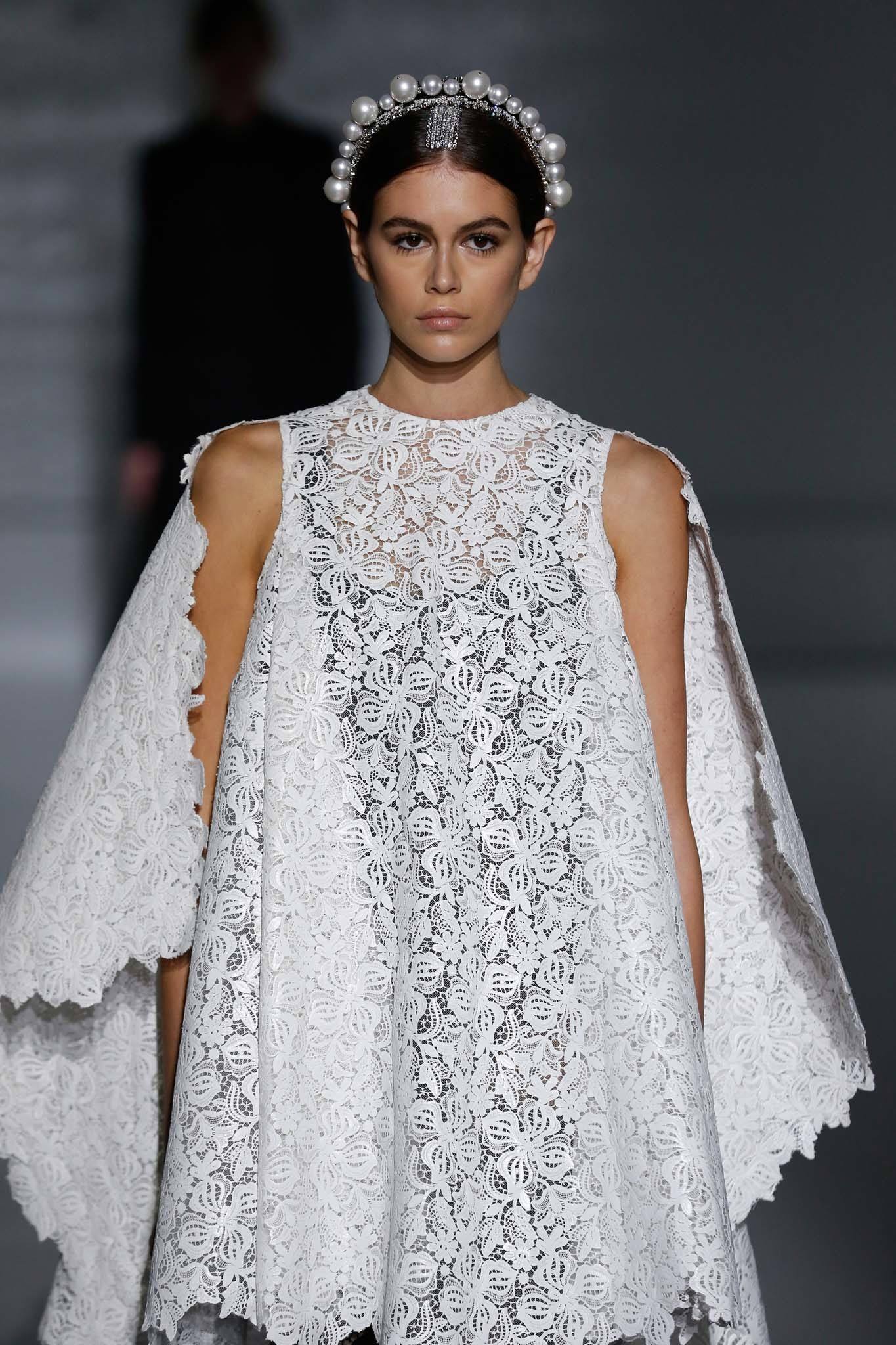 Haute Couture SS19; Kaia Gerber on Givenchy runway SS19 with brown hair in smooth low bun with jewelled tiara headband.
