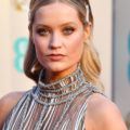 Red carpet hairstyles: Laura Whitmore with long wavy blonde hair pinned back with hair slides at the Baftas.