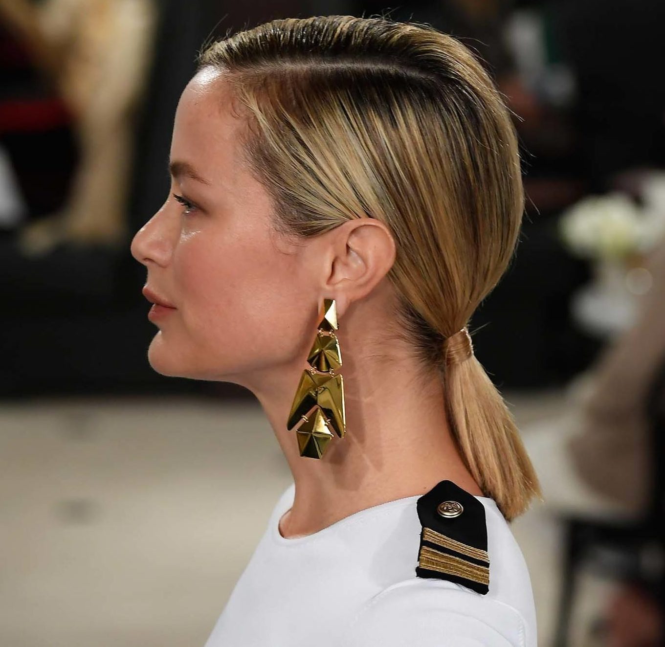 NYFW Catwalk Trends: Woman with short straight blonde hair in a low ponytail.
