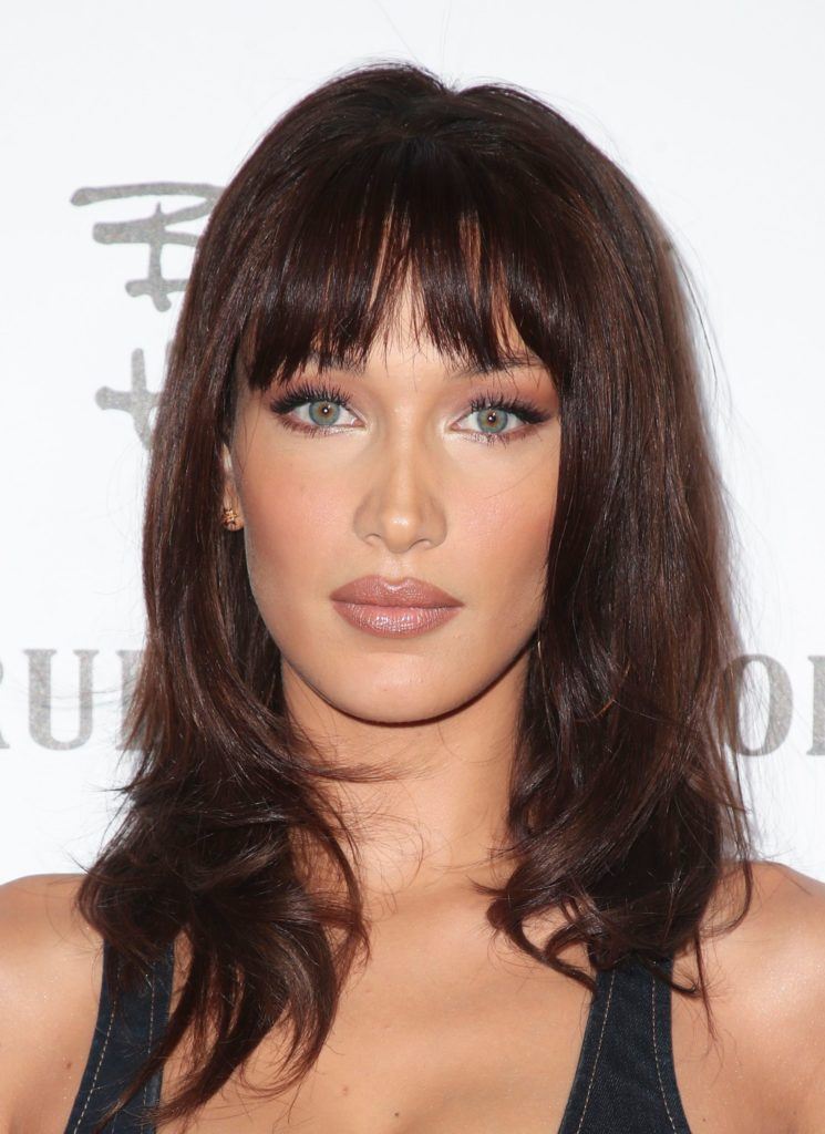 Winter hairstyles 2018: Close-up shot of Bella Hadid with '90s style layered hair and a choppy fringe