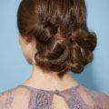 Diwali hairstyles: Close-up back view of a woman with brunette hair in a twisted chignon hairstyle