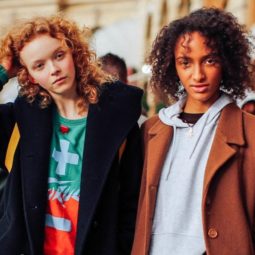 Hair treatment guide: Two models with ginger and brown medium curly hair, wearing winter jackets