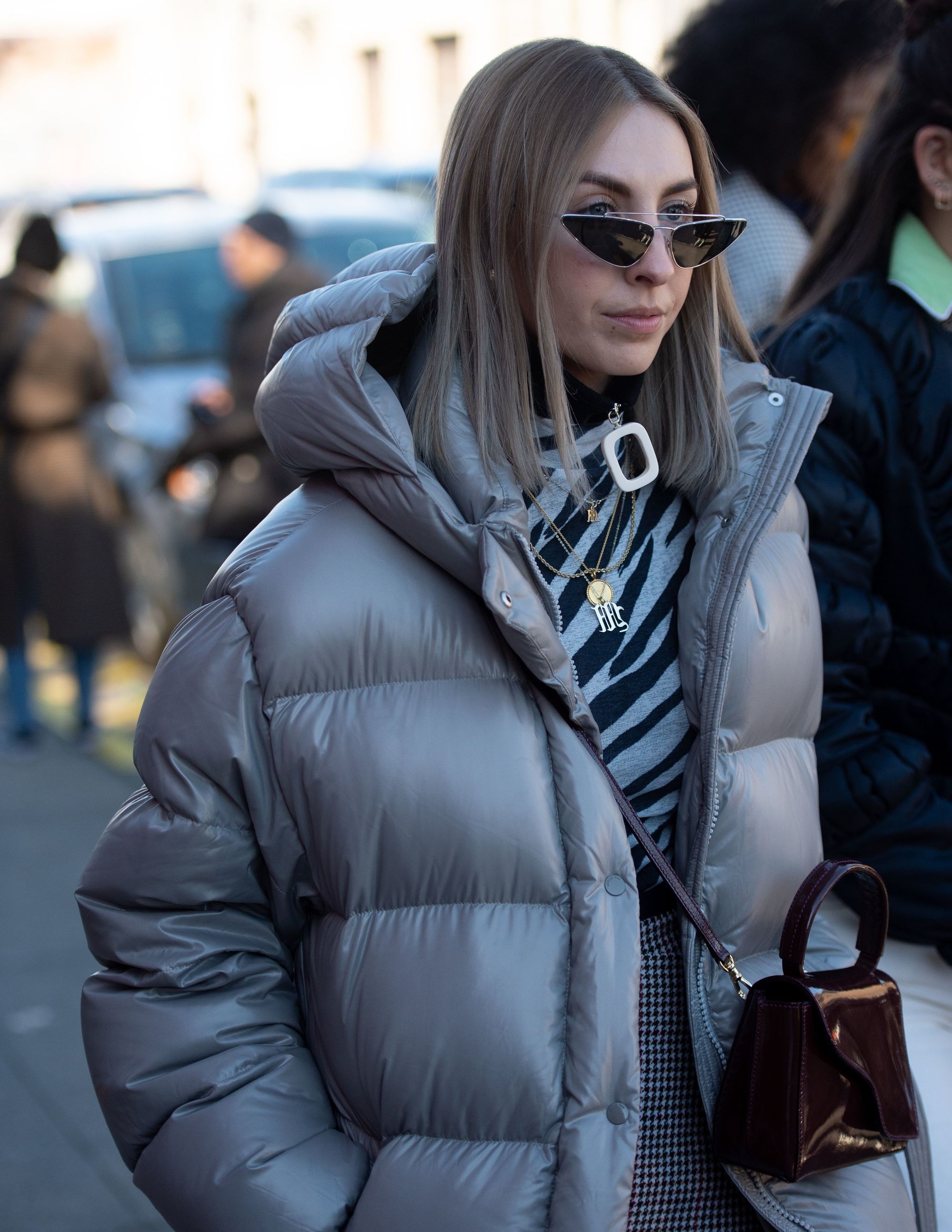 2019 hair colour trends: Street style shot of a woman with straight mushroom brown lob hair, wearing a grey puffa jacket