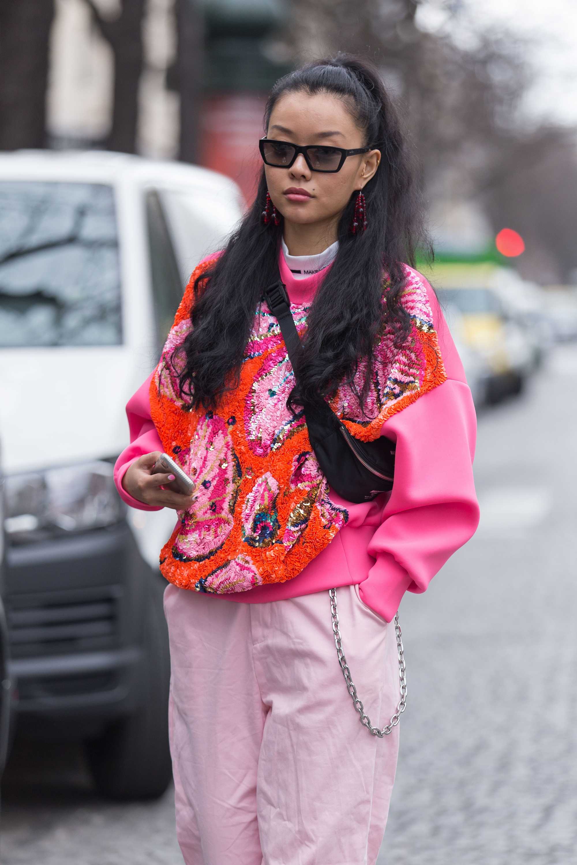 Paris Fashion Week Street Style: Woman with long brown hair in half-up, half-down ponytail wearing sunglasses