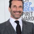 Hairstyles for men over 40: Photo of John Hamm with dark brown swept back hair and stubble