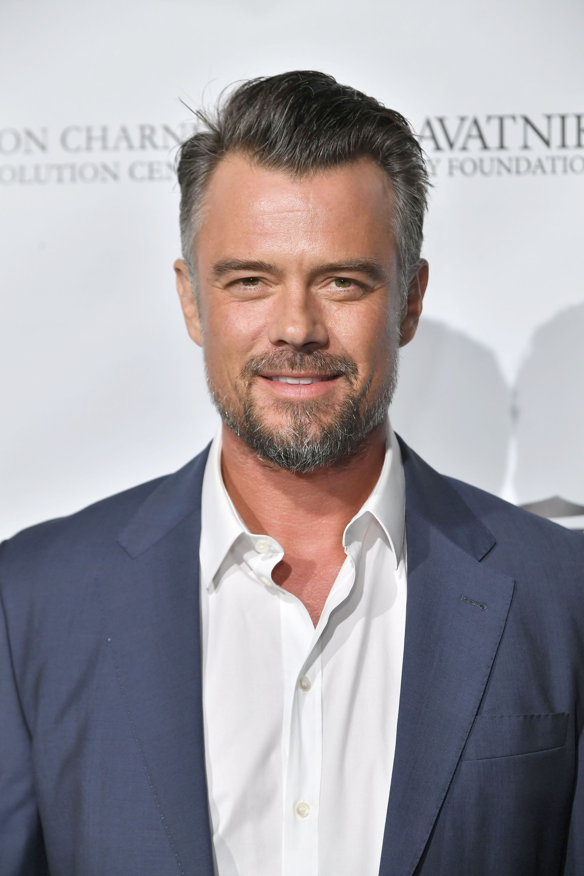 Hairstyles for men over 40: Photo of Josh Duhamel with dark grey side parted brush back hair