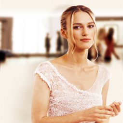 Love Actually: Kiera Knightley as Juliet with a lace wedding dress, with her golden blonde hair styled into romantic updo, posing on the set