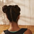 Back view of a woman with braided space buns