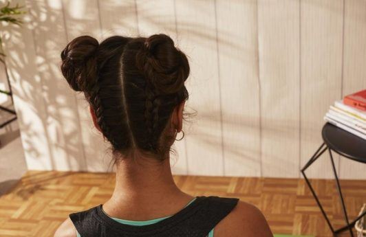 Back view of a woman with braided space buns