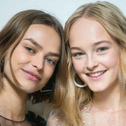 Flexible hold hairspray: Shot of two models with tousled, natural-looking waves, backstage, one with short light brown hair and the other with golden blonde hair