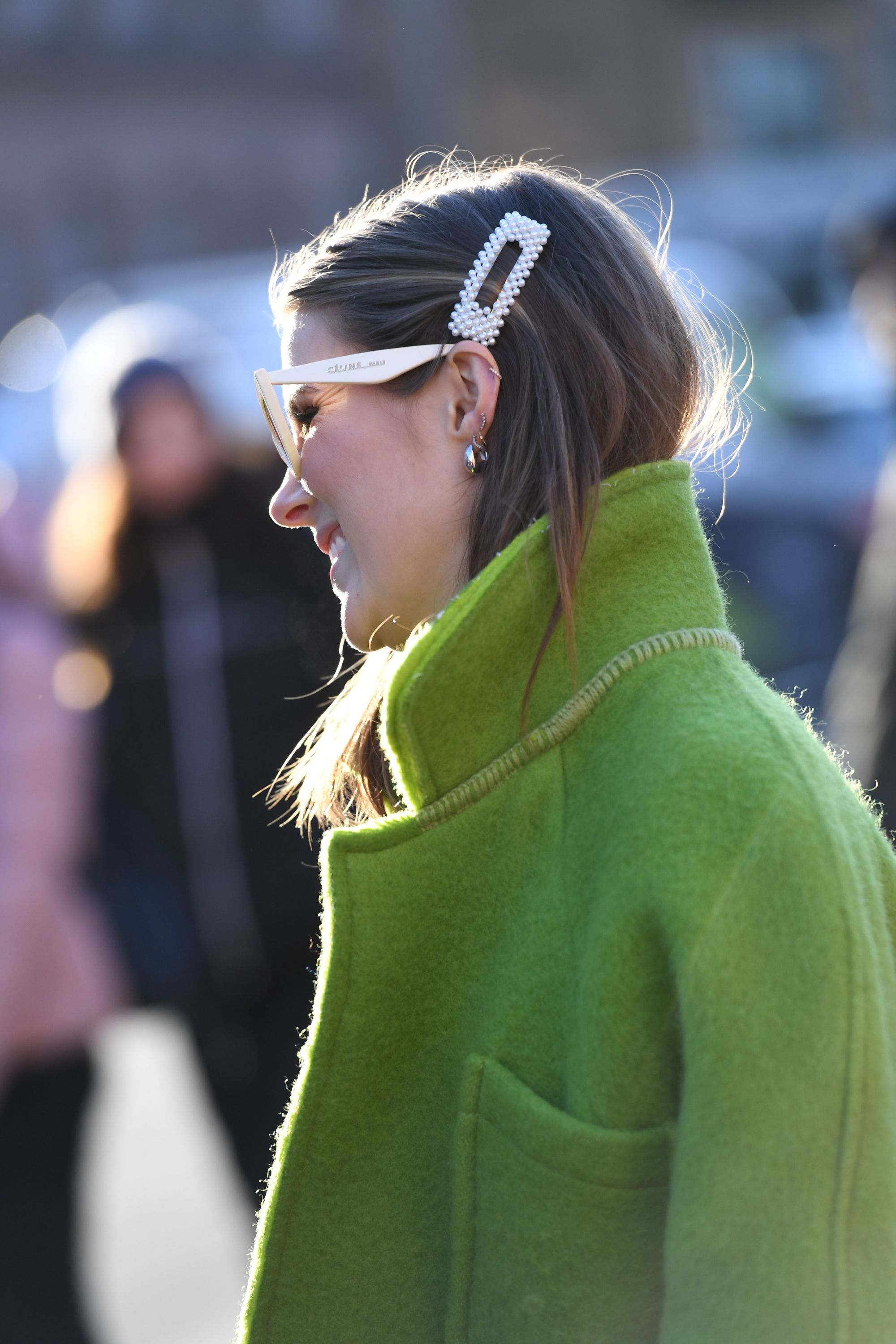 2019 Hair accessories: Street style shot of woman with her hair tucked into a green jacket. wearing a pearl hair clip with sunglasses at Copenhagen fashion week