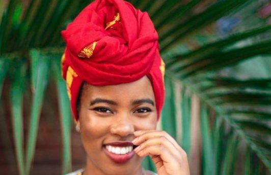 The Day I Went Natural: Shot of Dr. Alexandra Oti wearing a headwrap and posing outside