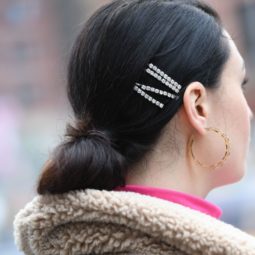Diamante hair trend: Back side view photo of a street styler with dark hair in a low bun with four diamante encrusted hair slides
