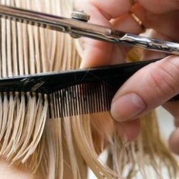 close up of a comb in blonde hair with scissors